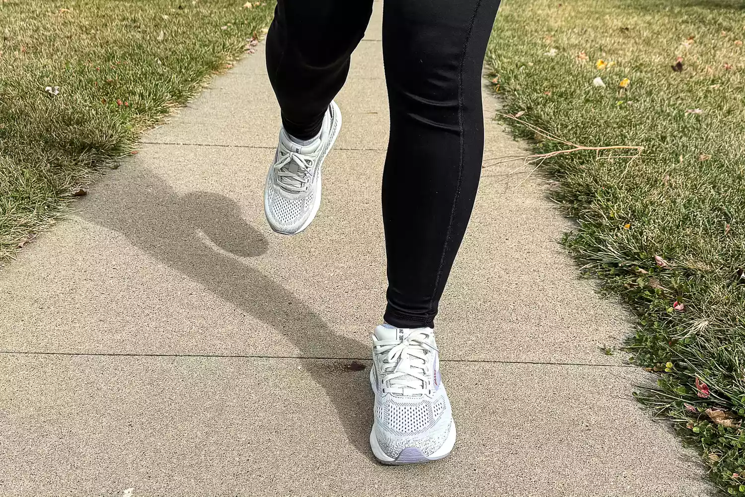 A person runs outside while wearing the Brooks Women's Ariel GTS 24 Running Shoes