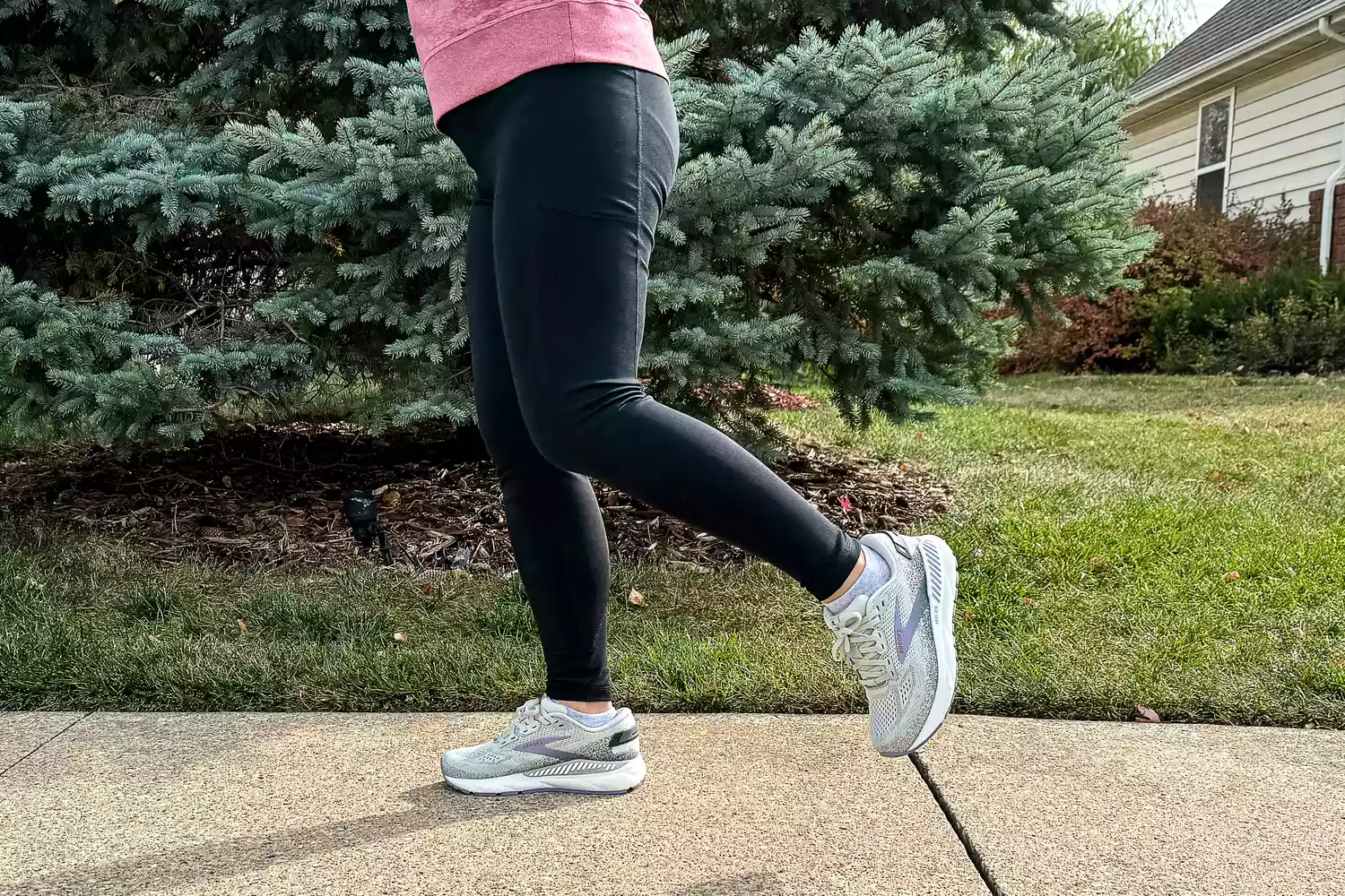 A person jogs while wearing the Brooks Women's Ariel GTS 24 Running Shoes