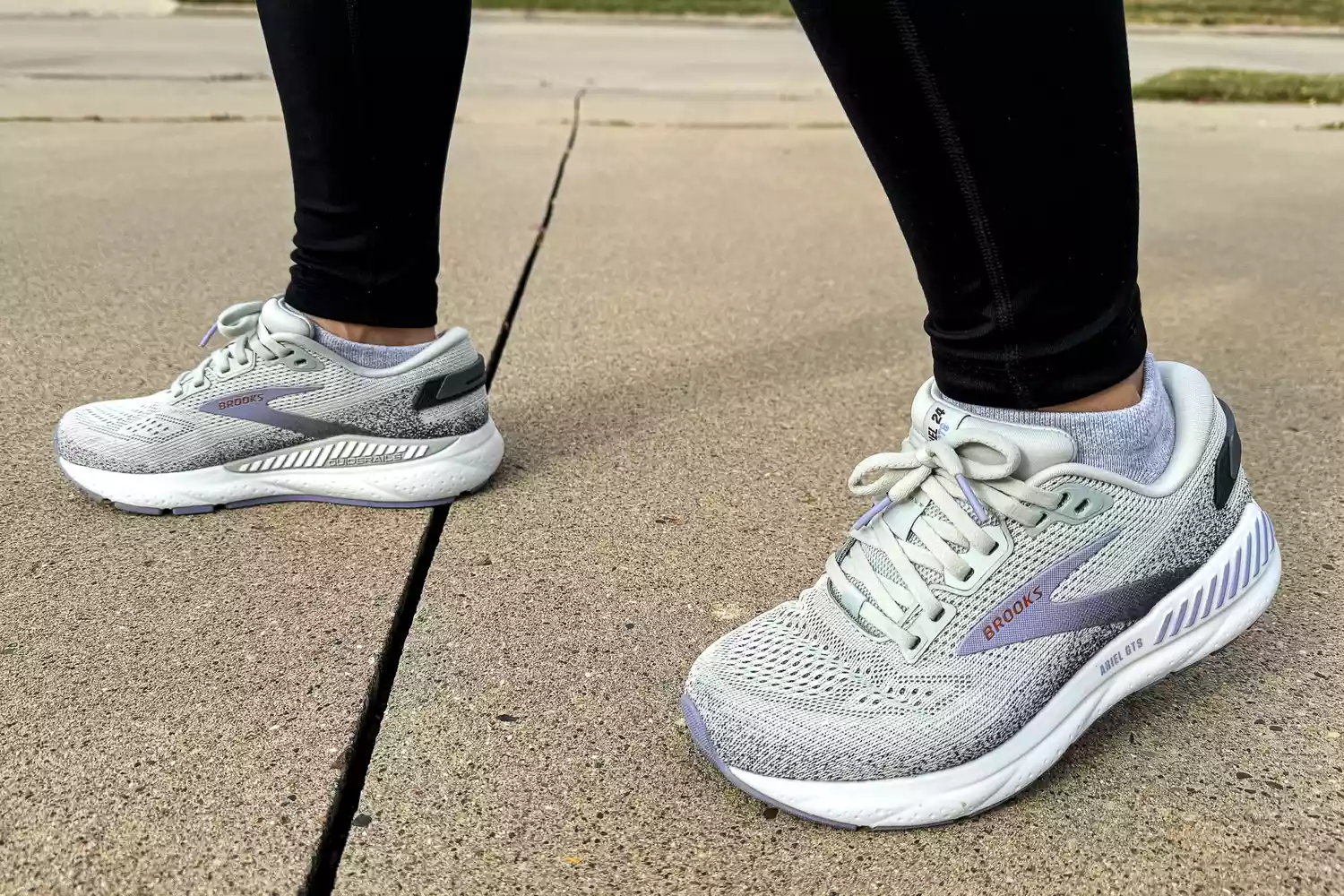 A person walks outside while wearing the Brooks Women's Ariel GTS 24 Running Shoes