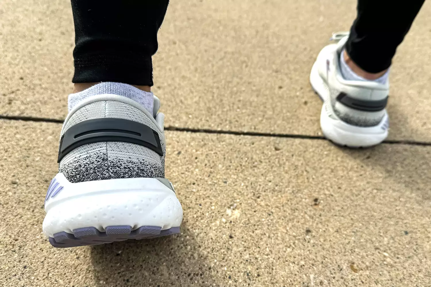 A person walks outside while wearing the Brooks Women's Ariel GTS 24 Running Shoes