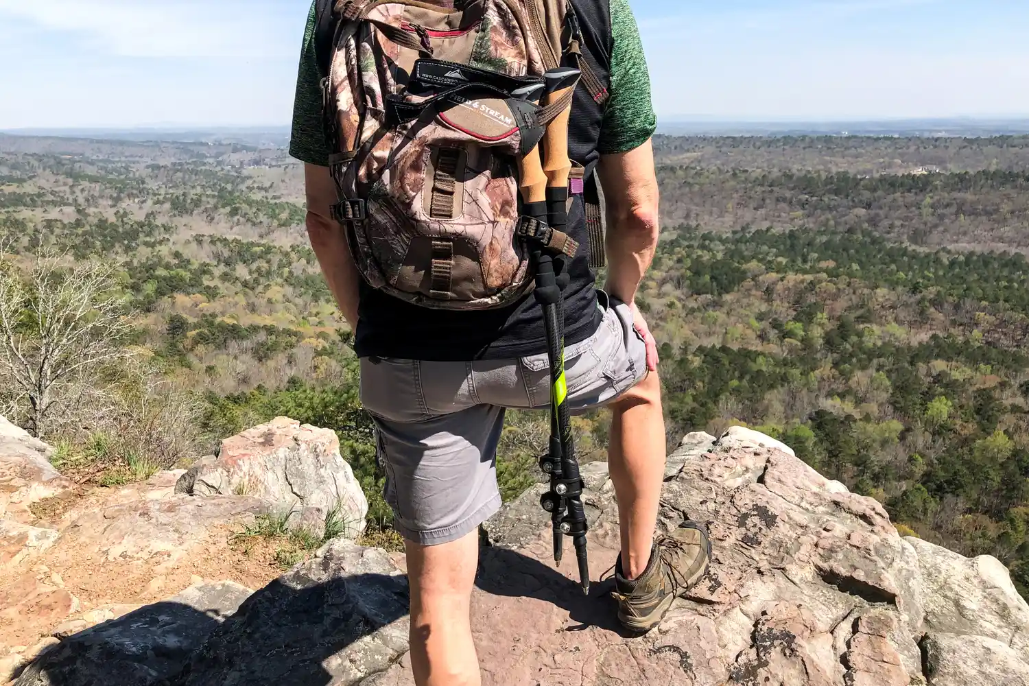 The Cascade Mountain Tech Carbon Fiber Quick Lock Trekking Poles packed into a backpack