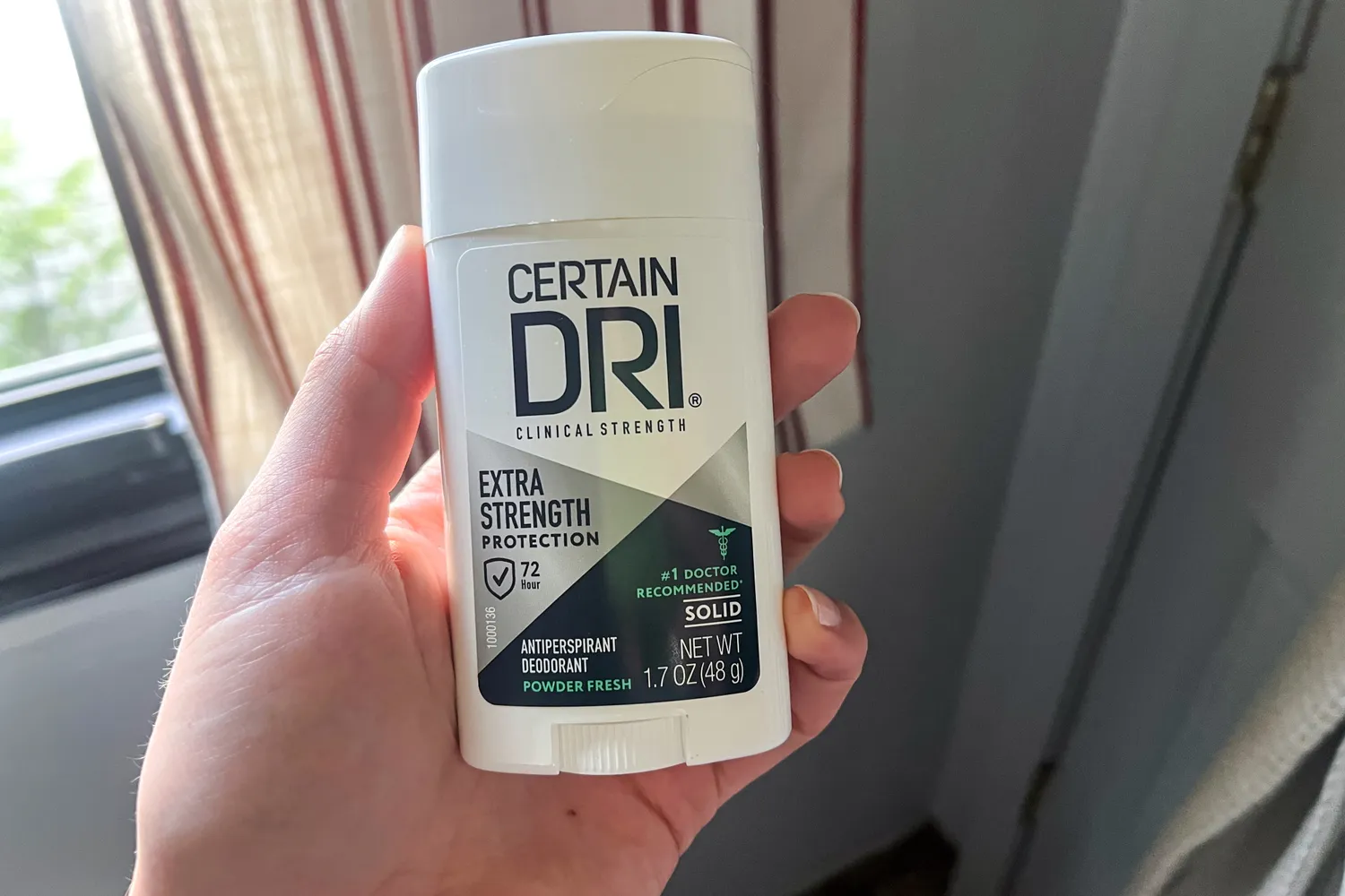 A person holds up the Certain Dri Extra Strength Antiperspirant Deodorant
