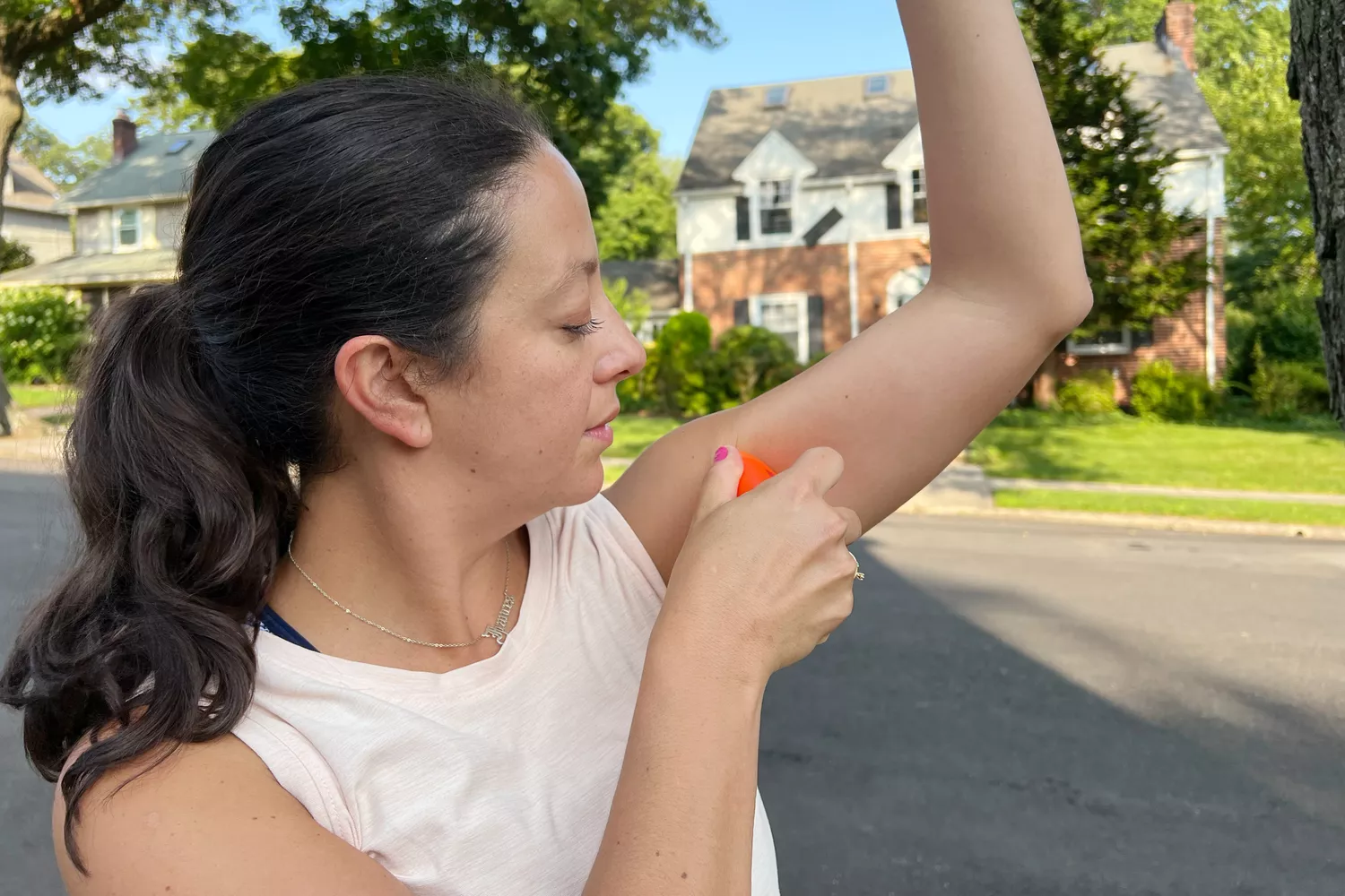 A person applies Hiki Anti-Chafe Stick