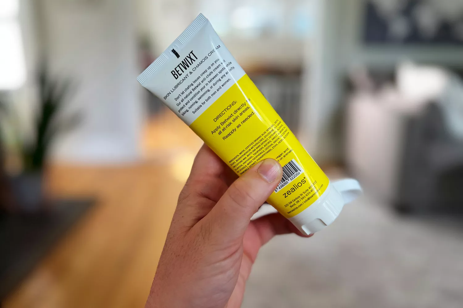 A person holds a tube of Zealios Betwixt Sports & Athletic Anti-Chafe Cream