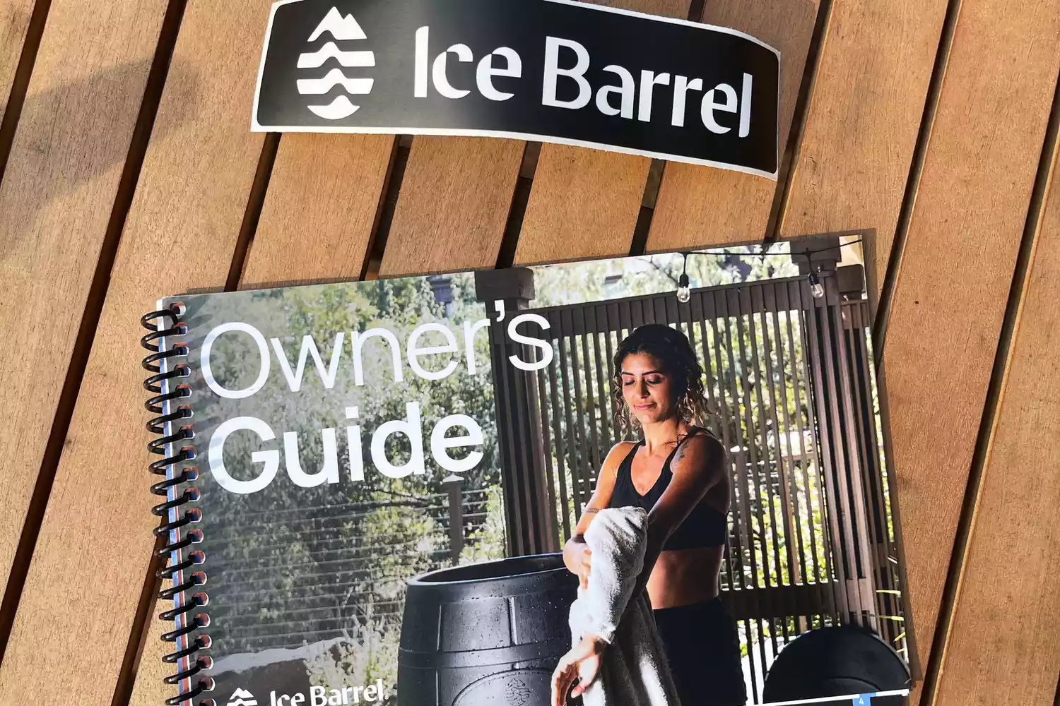 Ice Barrel 400 Cold Therapy Training Tool's owner's guide on a wooden surface