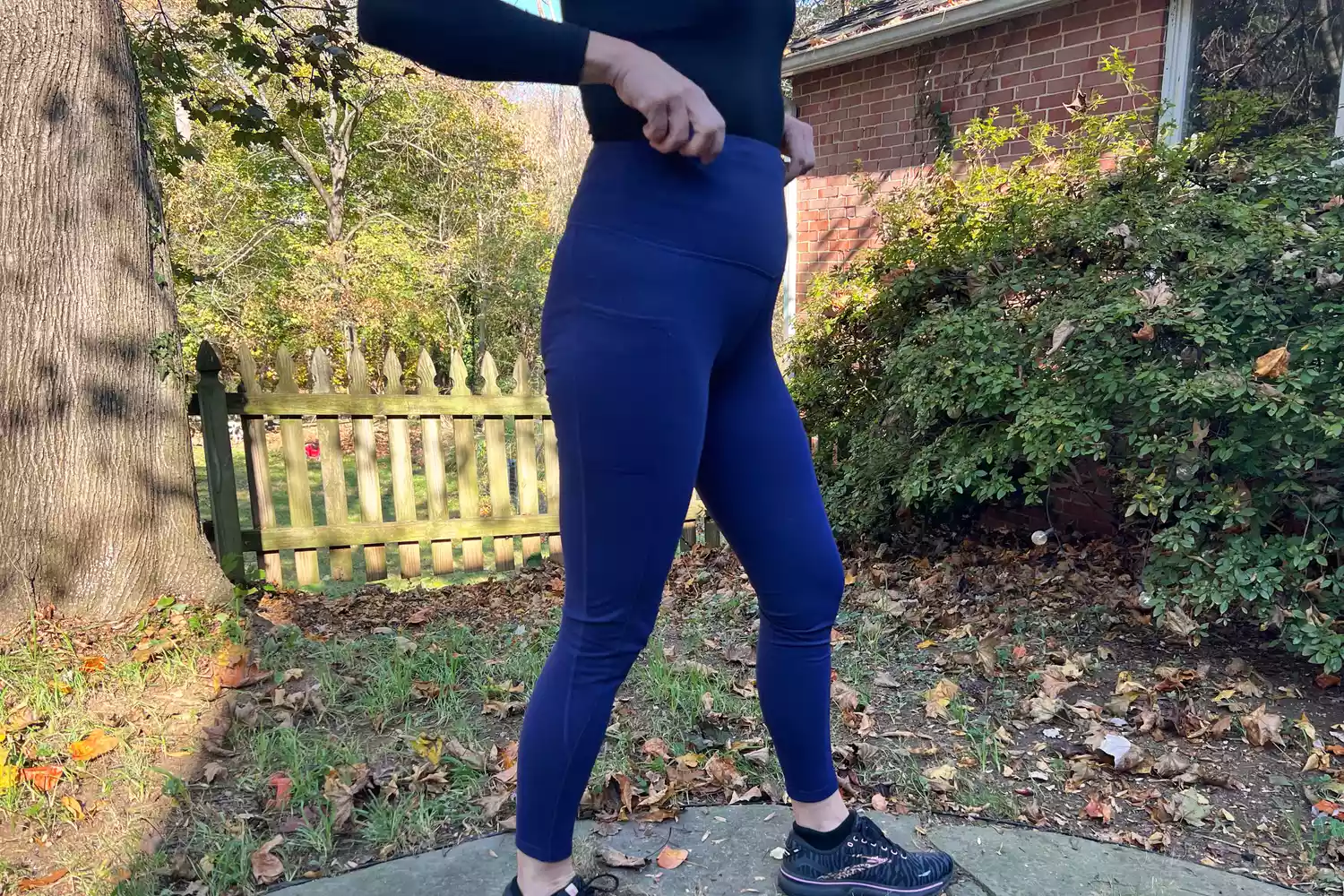 Person pulling up the waist to a Baleaf Women's Laureate Thermal Water-Resistant Leggings