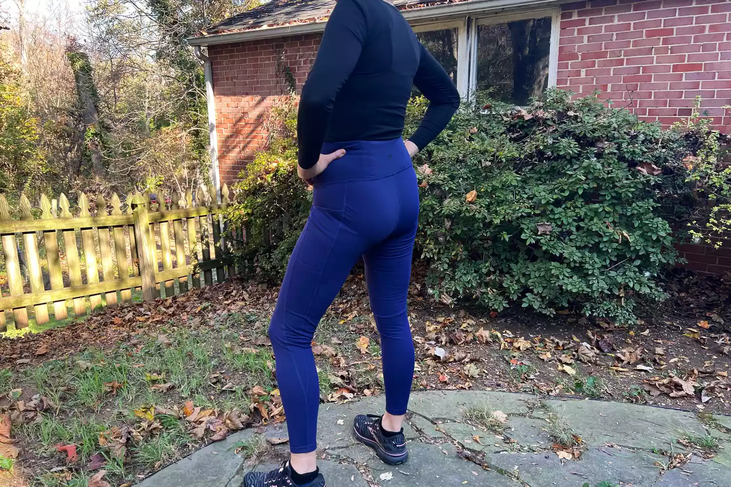 Person standing outside showing the back of Baleaf Women's Laureate Thermal Water-Resistant Leggings