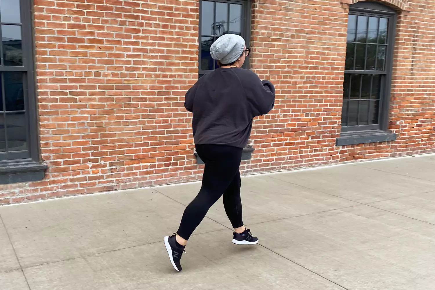 Person running outside wearing Nike Therma-FIT One Womenâs High-Waisted â Leggings