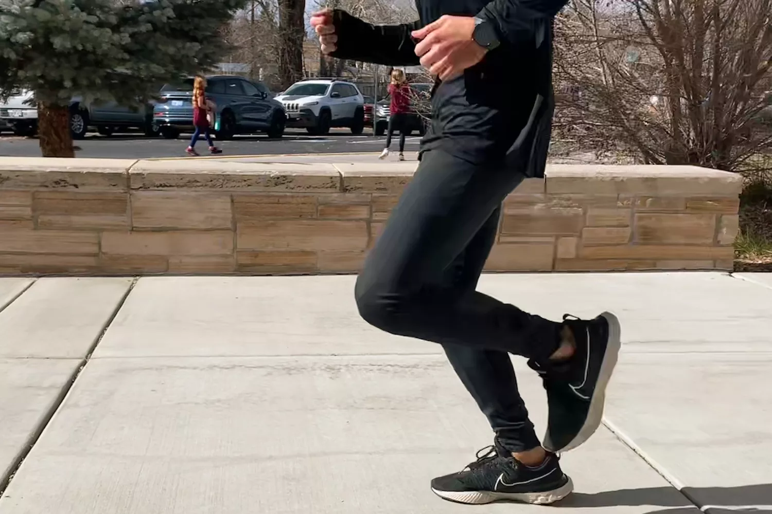 Person running outside wearing Tracksmith Menâs NDO Tights