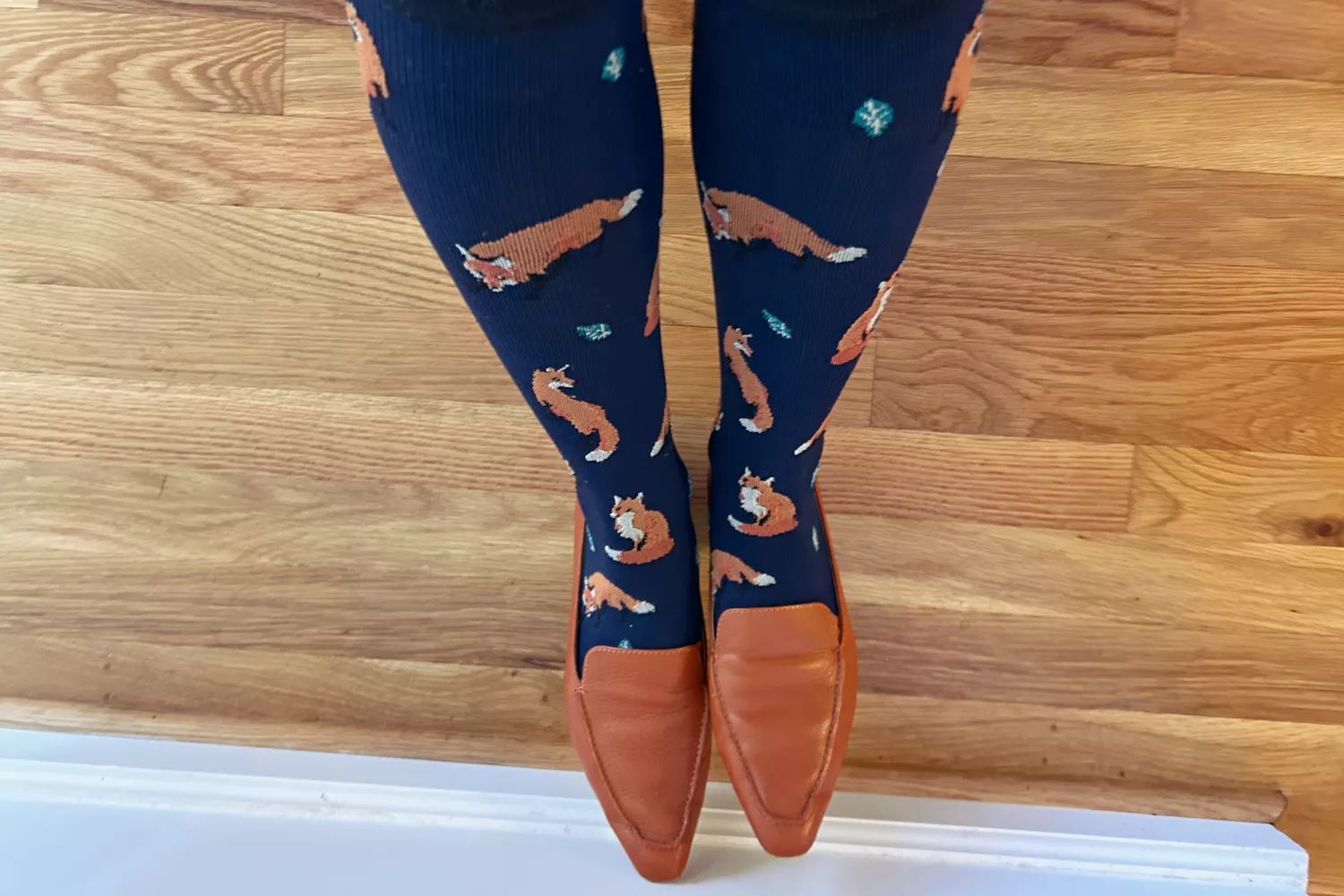 Person wearing Levsox Compression Socks adorned with foxes