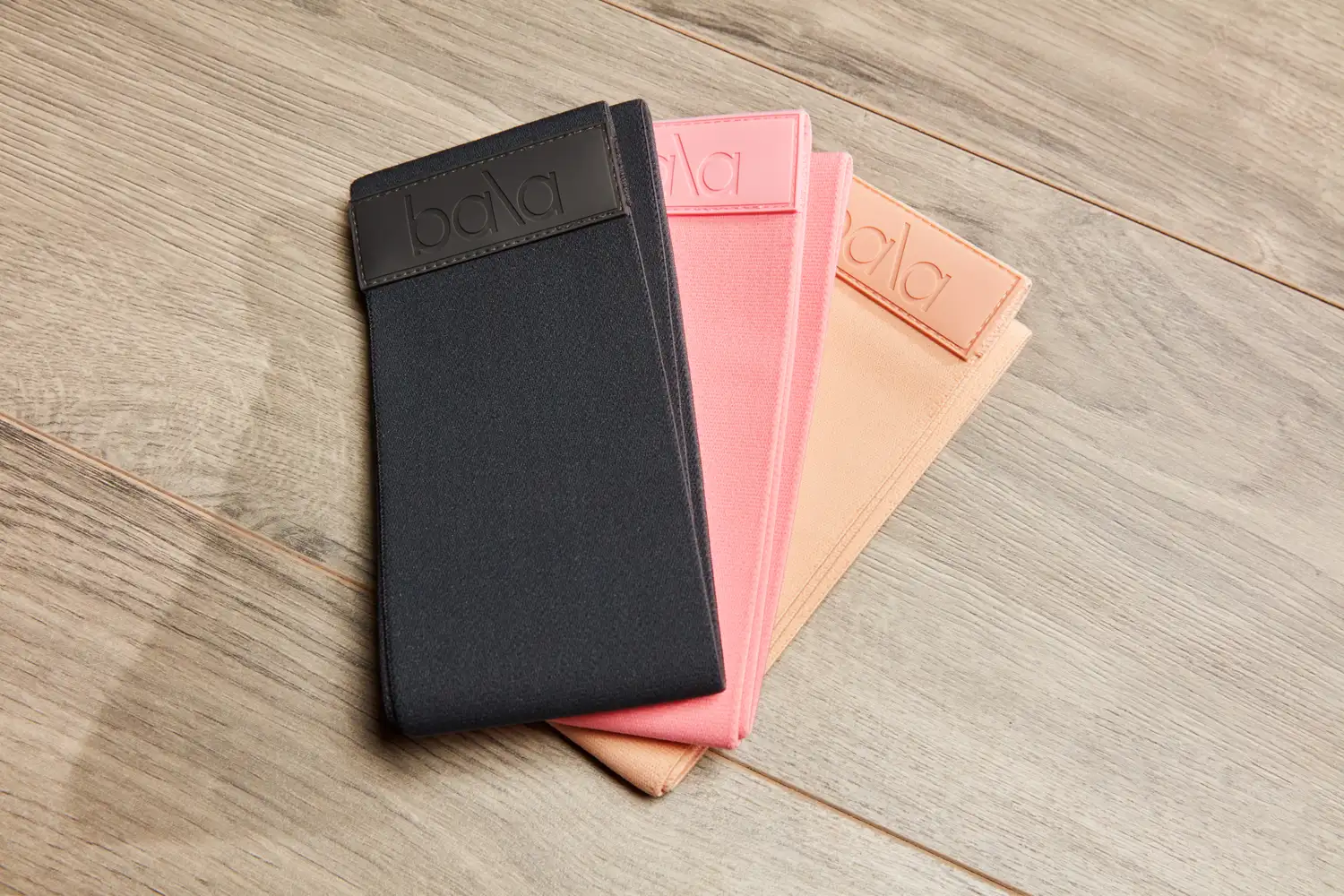 Three Bala Bands arranged on a wooden surface