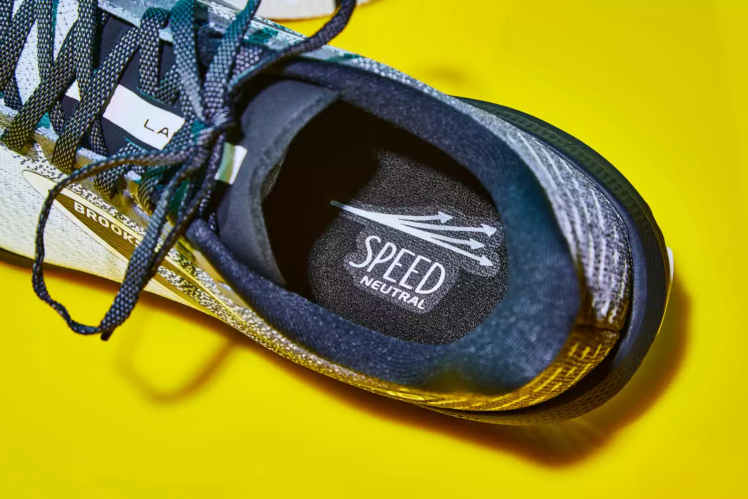 A top-down look at the Brooks Launch 10 on a shiny yellow surface