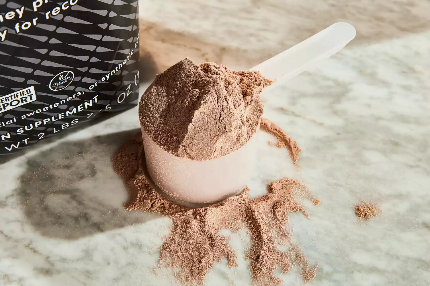 Ladder Whey Protein Powder in a scoop on a table