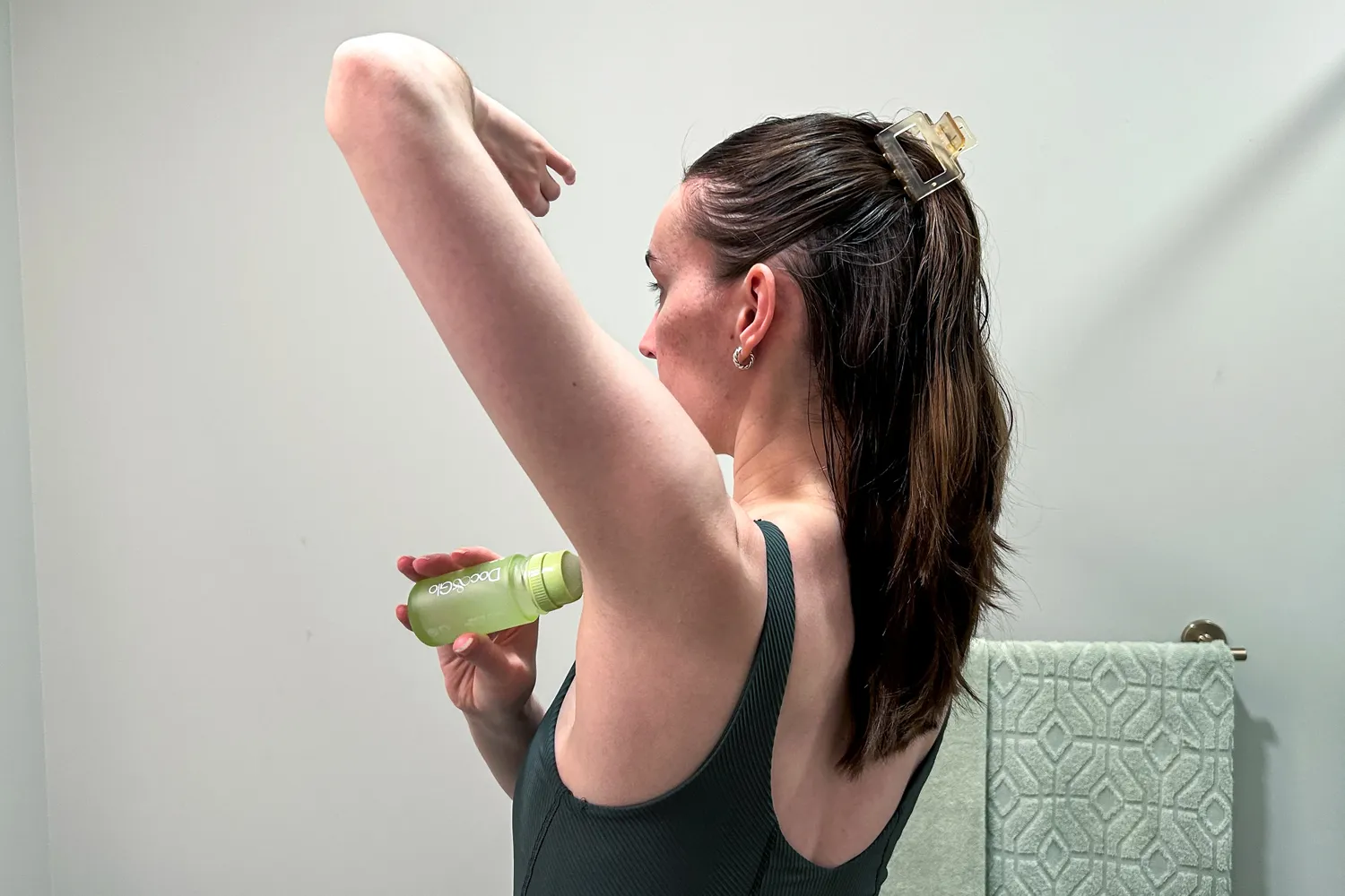 A person applies Doc&Glo No. 3161 Game Changing Deodorant to their underarm