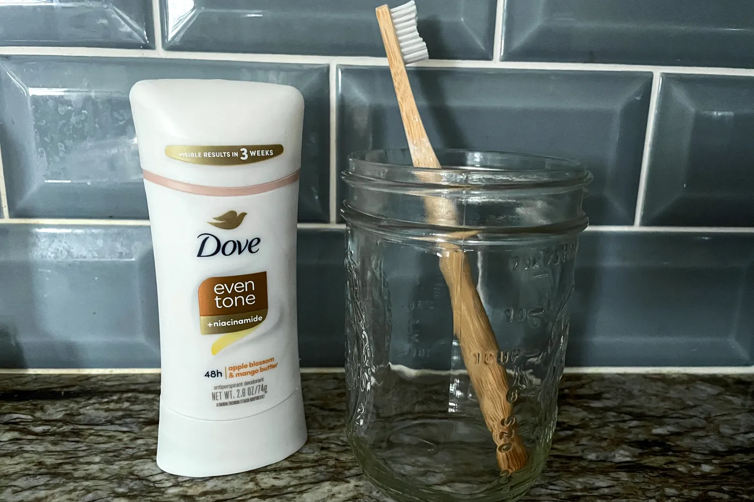 The Dove Even Tone 48-Hour Antiperspirant & Deodorant Stick next to a toothbrush in a glass