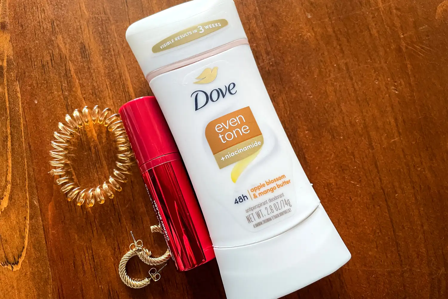 The Dove Even Tone 48-Hour Antiperspirant & Deodorant Stick next to beauty items