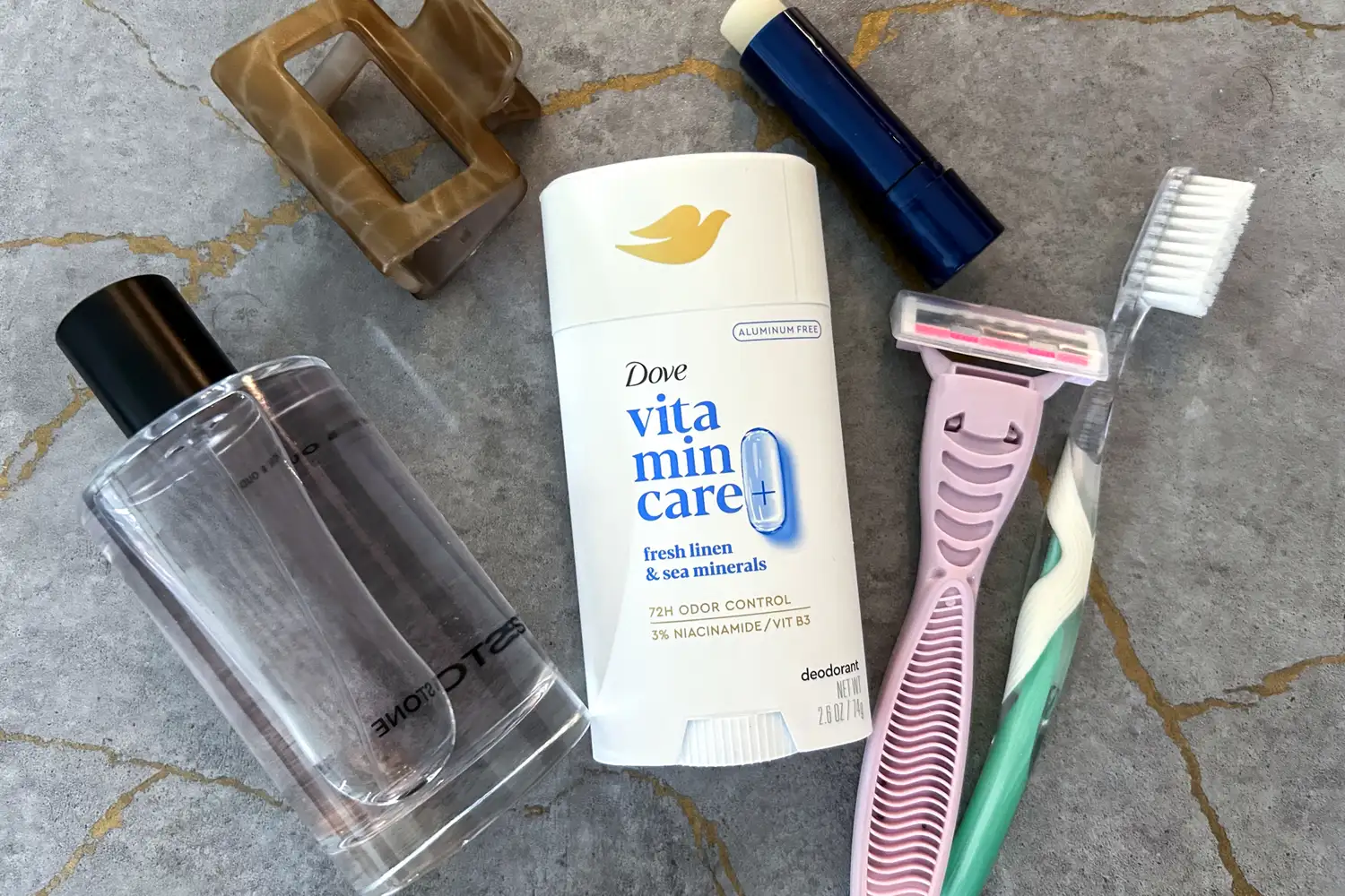 The Dove VitaminCare+ Deodorant Stick on a table with other toiletries