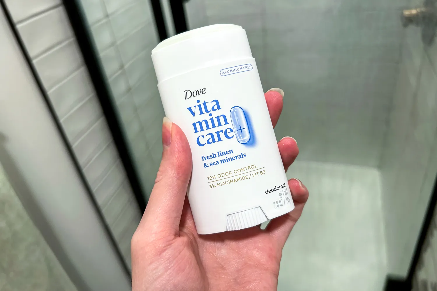 A person holds up the Dove VitaminCare+ Deodorant Stick