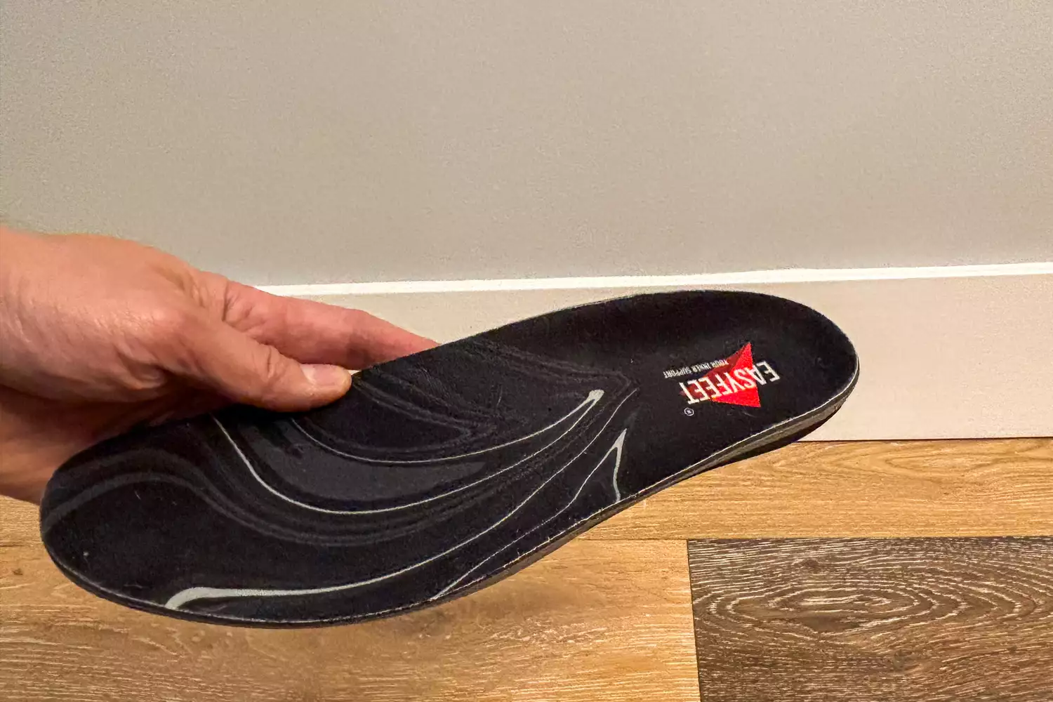 A person holds up the EasyFeet Black Onyx Pain Relief Premium Orthotic