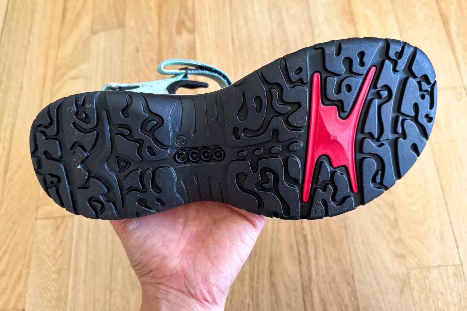 A hand showing the bottom of the ECCO Offroad Roam Women's Nubuck Outdoor Sandal