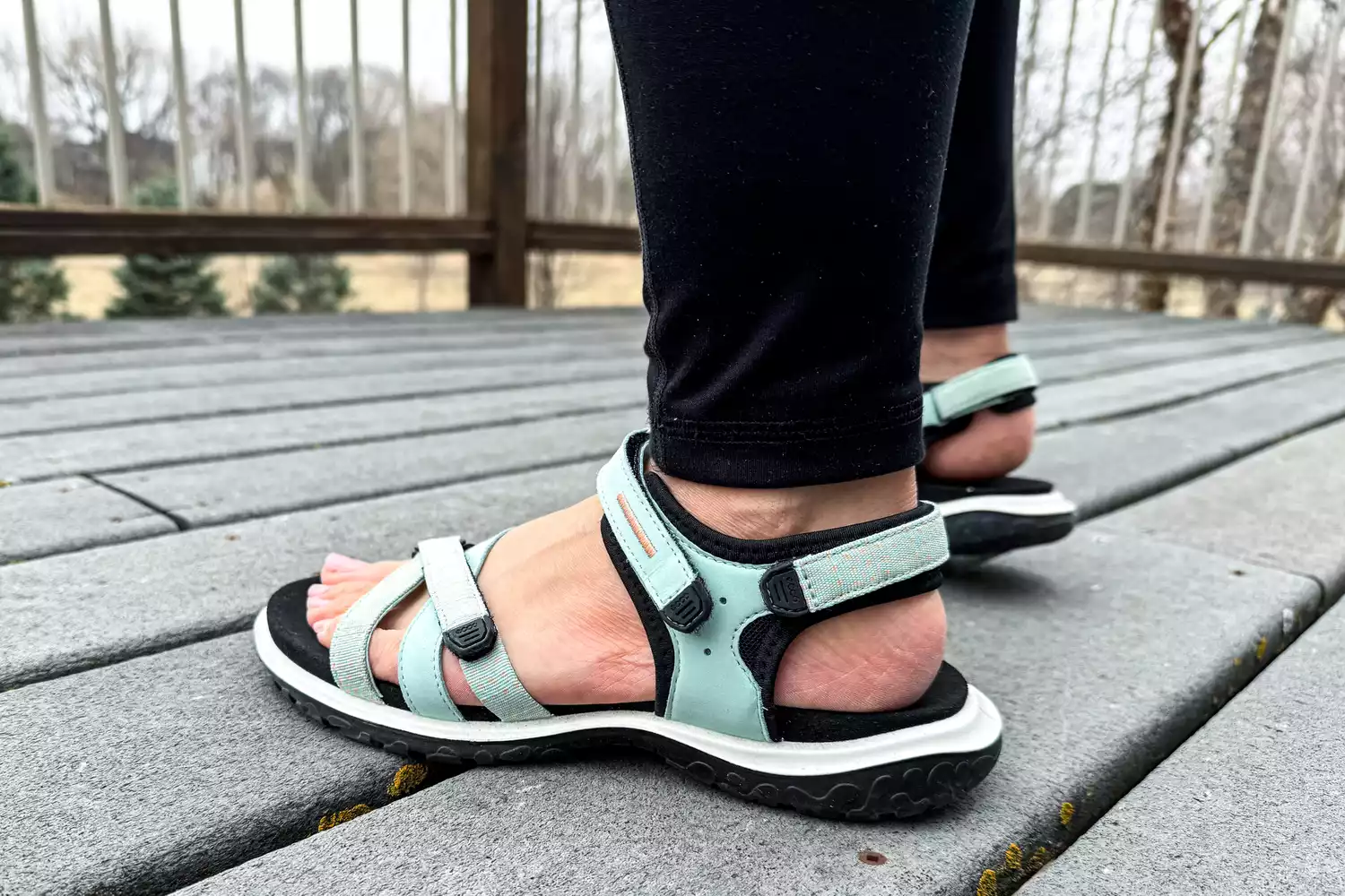 Two feet posed to show the side of the ECCO Offroad Roam Women's Nubuck Outdoor Sandal outside
