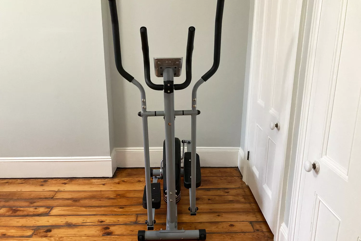 The EFITMENT Magnetic Elliptical Machine in the corner of a room next to closets