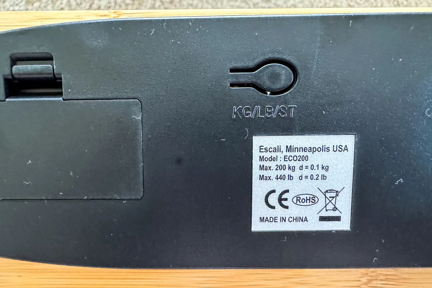 The manufacturing information and battery compartment on the Escali Bamboo Digital Electronic Bathroom Scale