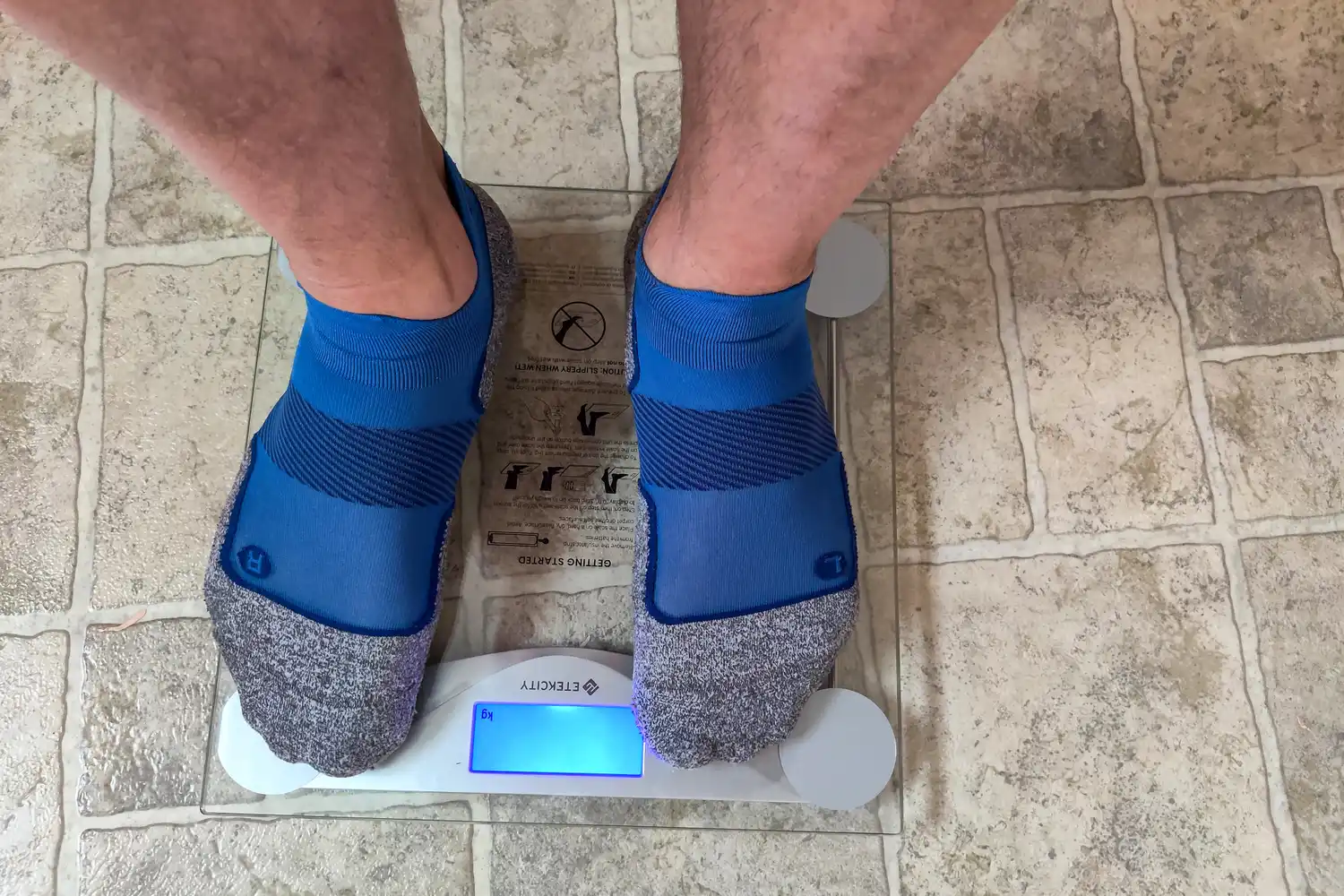 A person stands on the Etekcity EB4074C Digital Body Weight Scale
