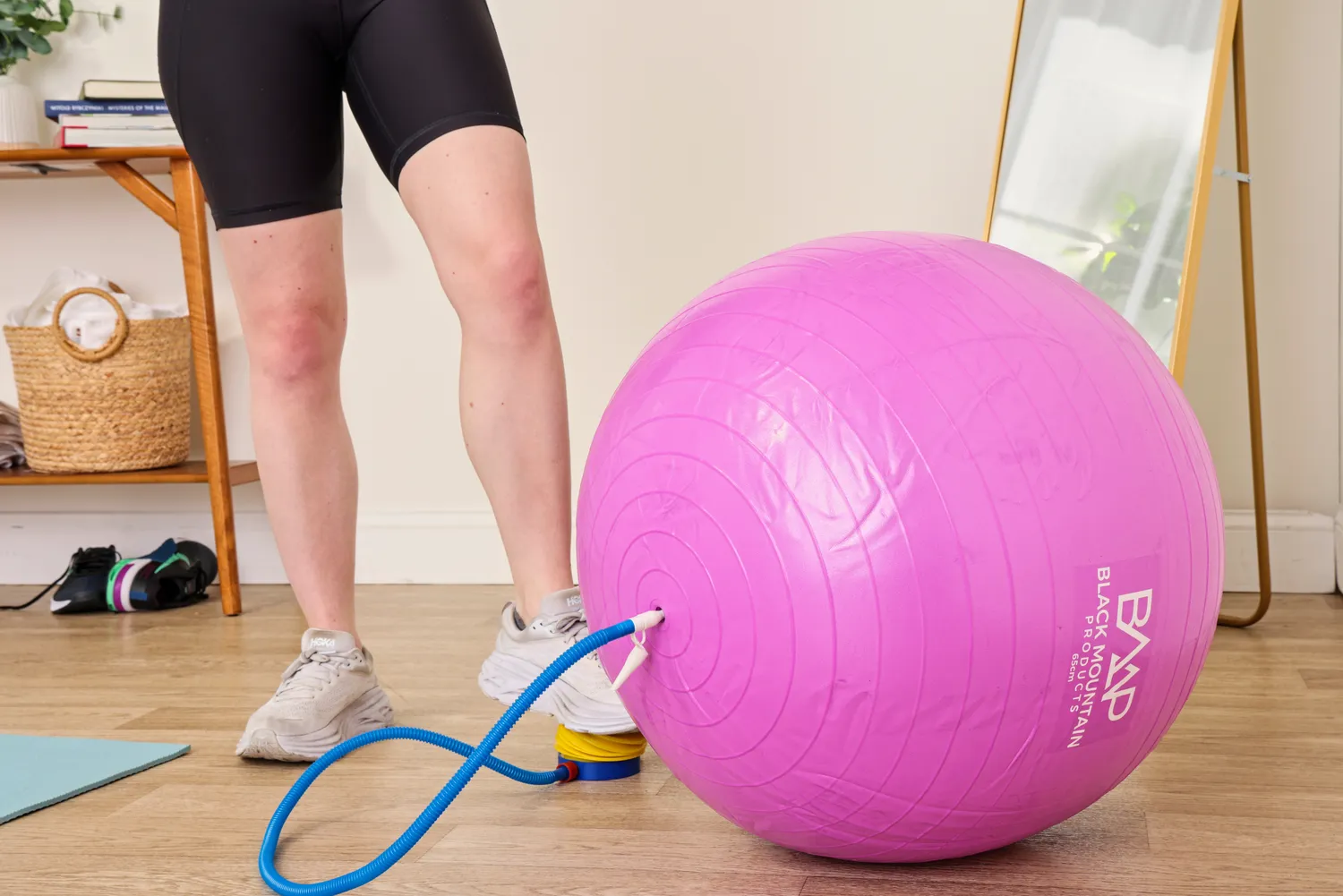 A person pumps up the Black Mountain Professional Grade Stability Ball