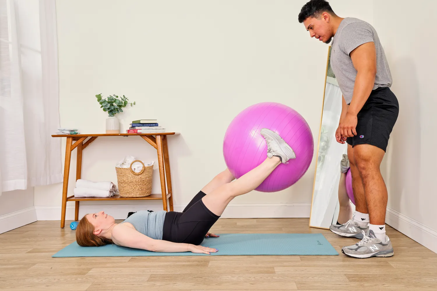 A person lifts the Black Mountain Professional Grade Stability Ball with their legs