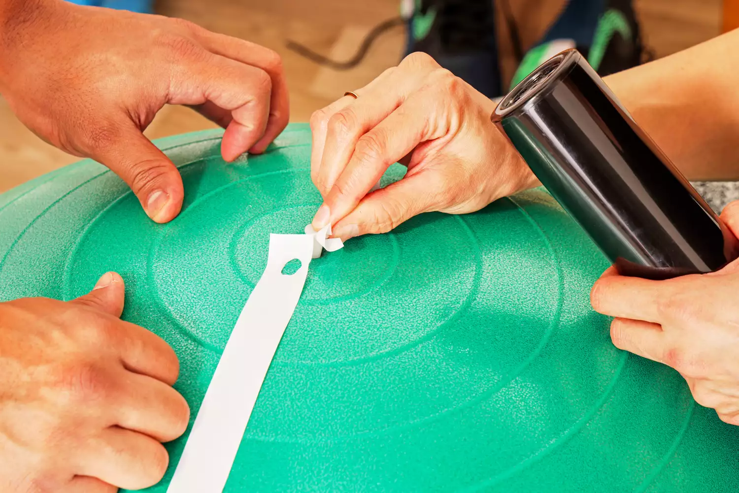 A person assembles the Gaiam Total Body Balance Ball Kit