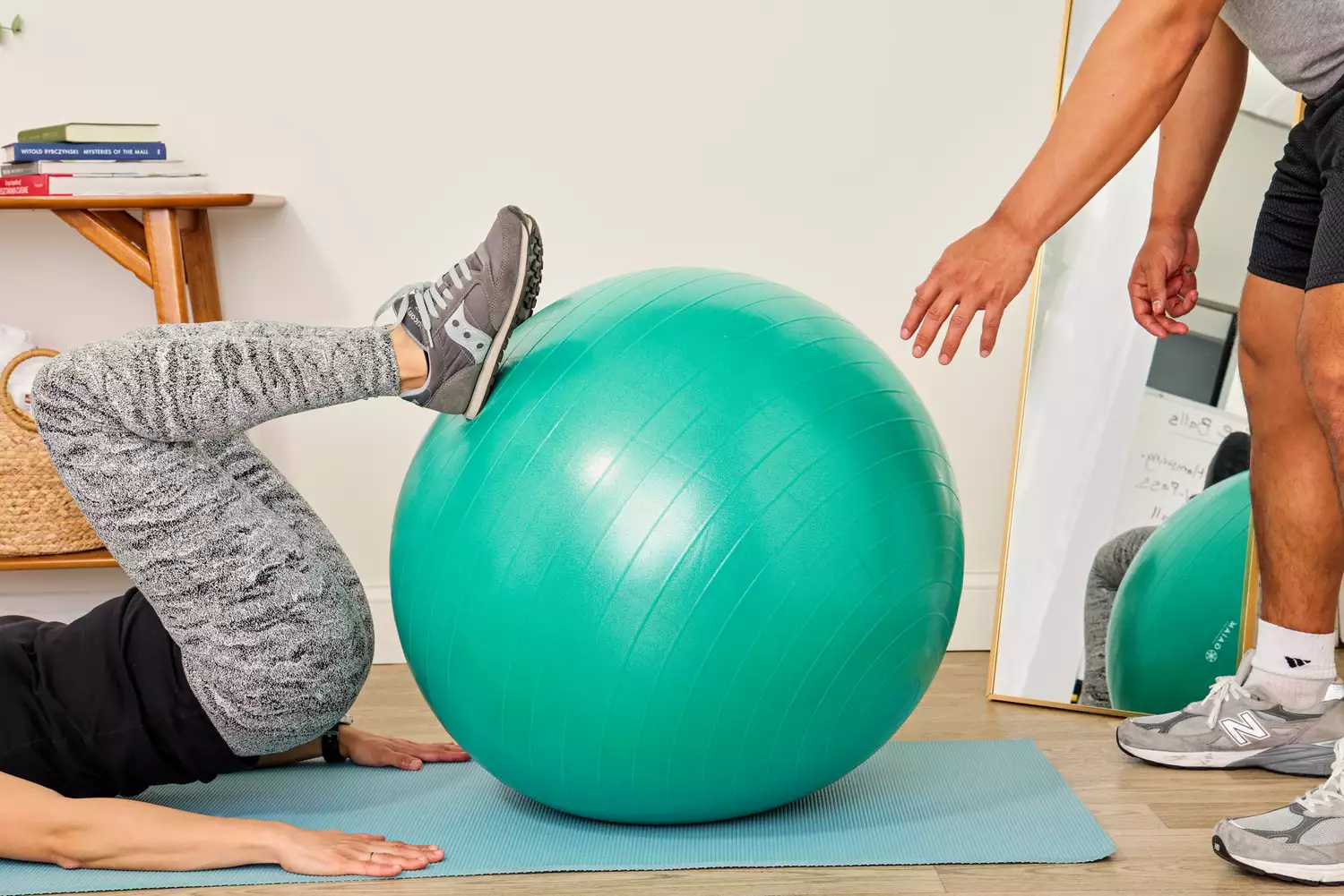 A person exercises using the Gaiam Total Body Balance Ball Kit