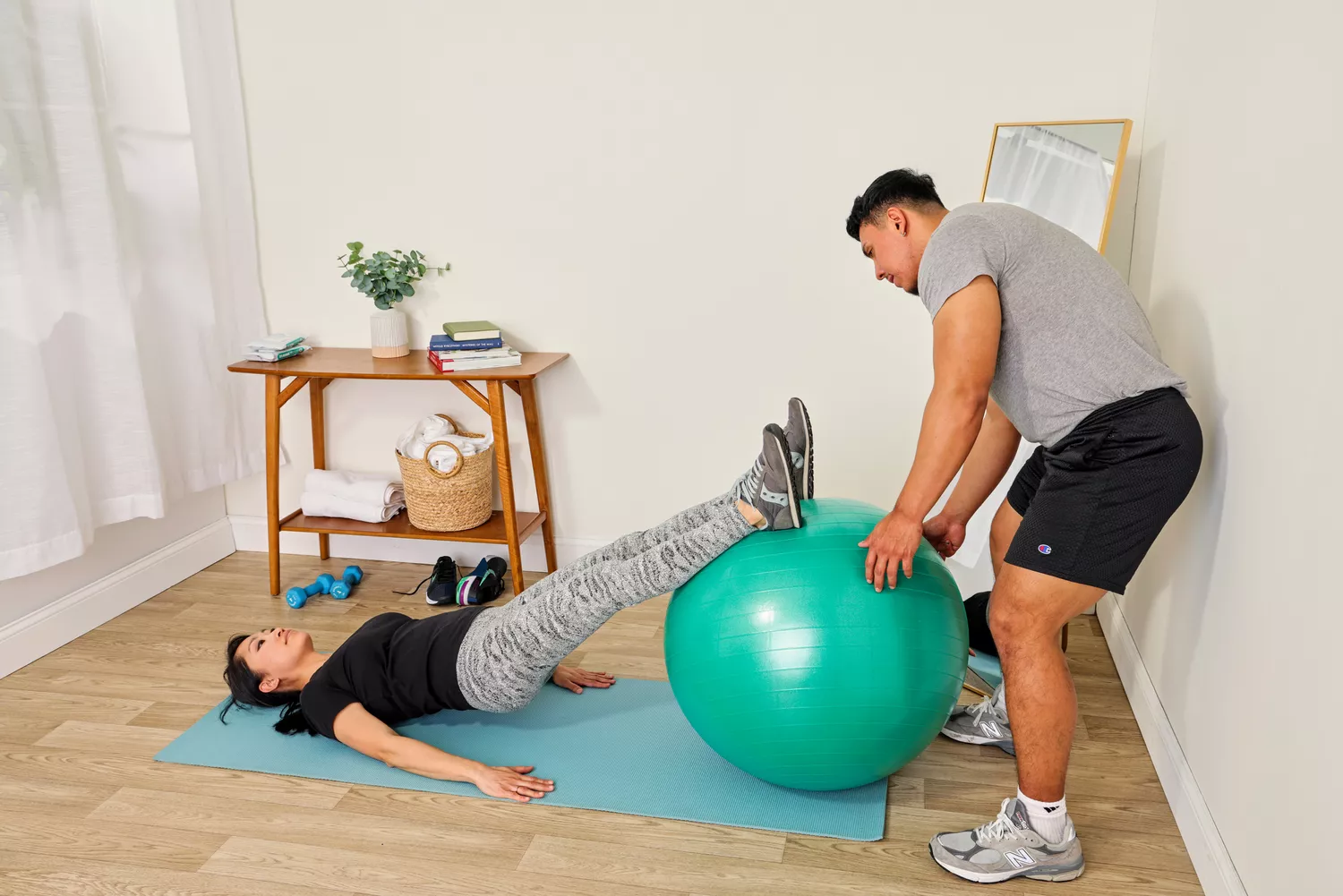 A person uses the Gaiam Total Body Balance Ball Kit to exercise