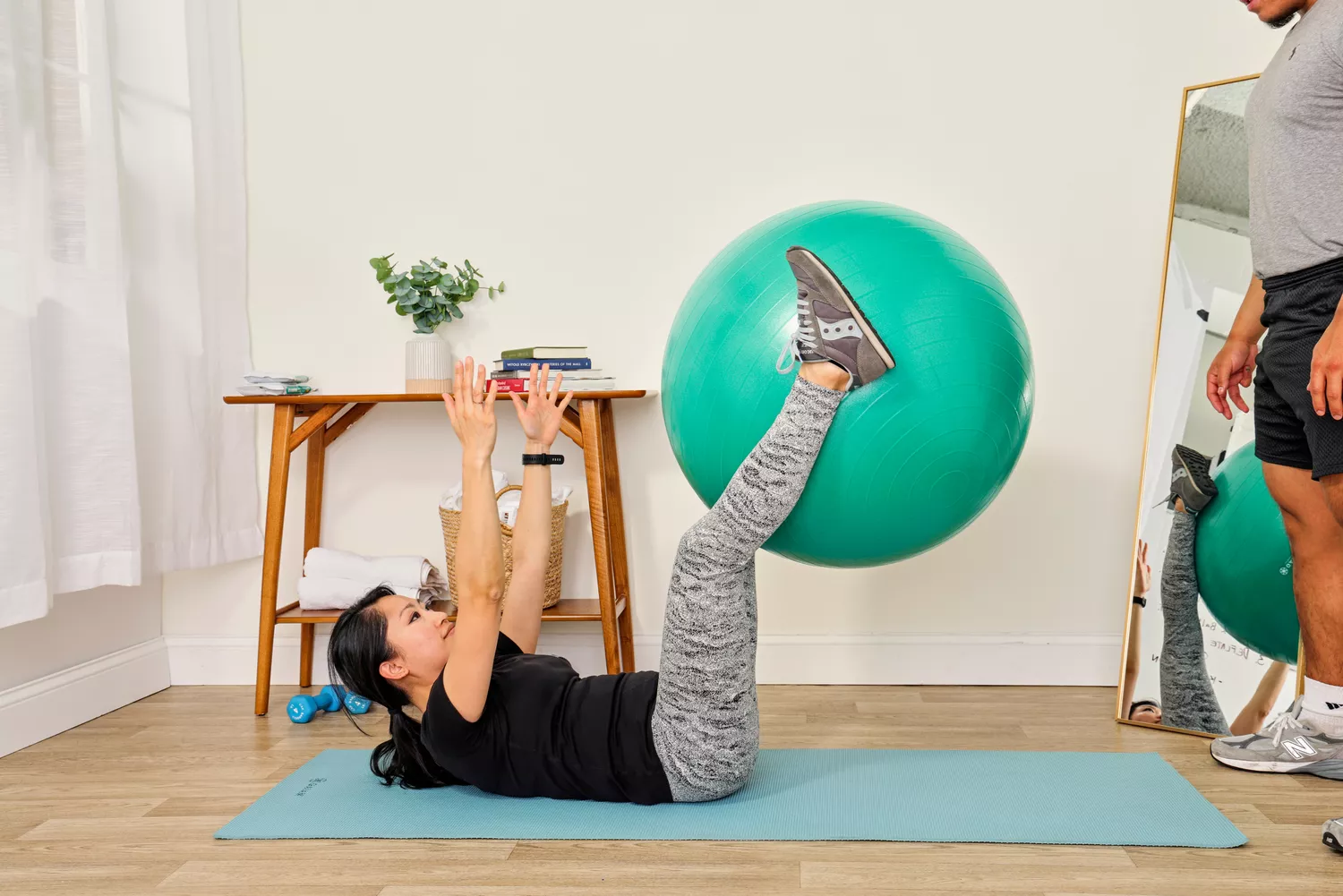 A person exercises using the Gaiam Total Body Balance Ball Kit