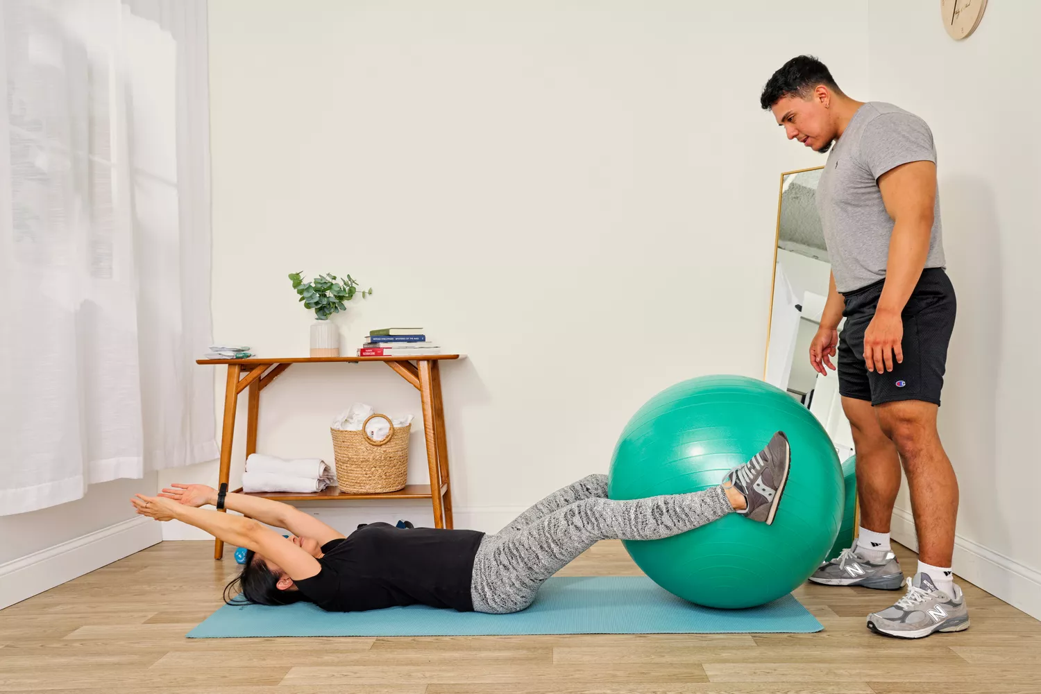 A person exercises using the Gaiam Total Body Balance Ball Kit