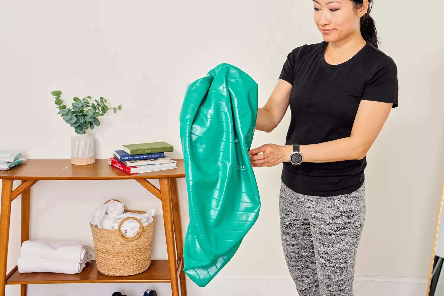A person deflates the Gaiam Total Body Balance Ball Kit
