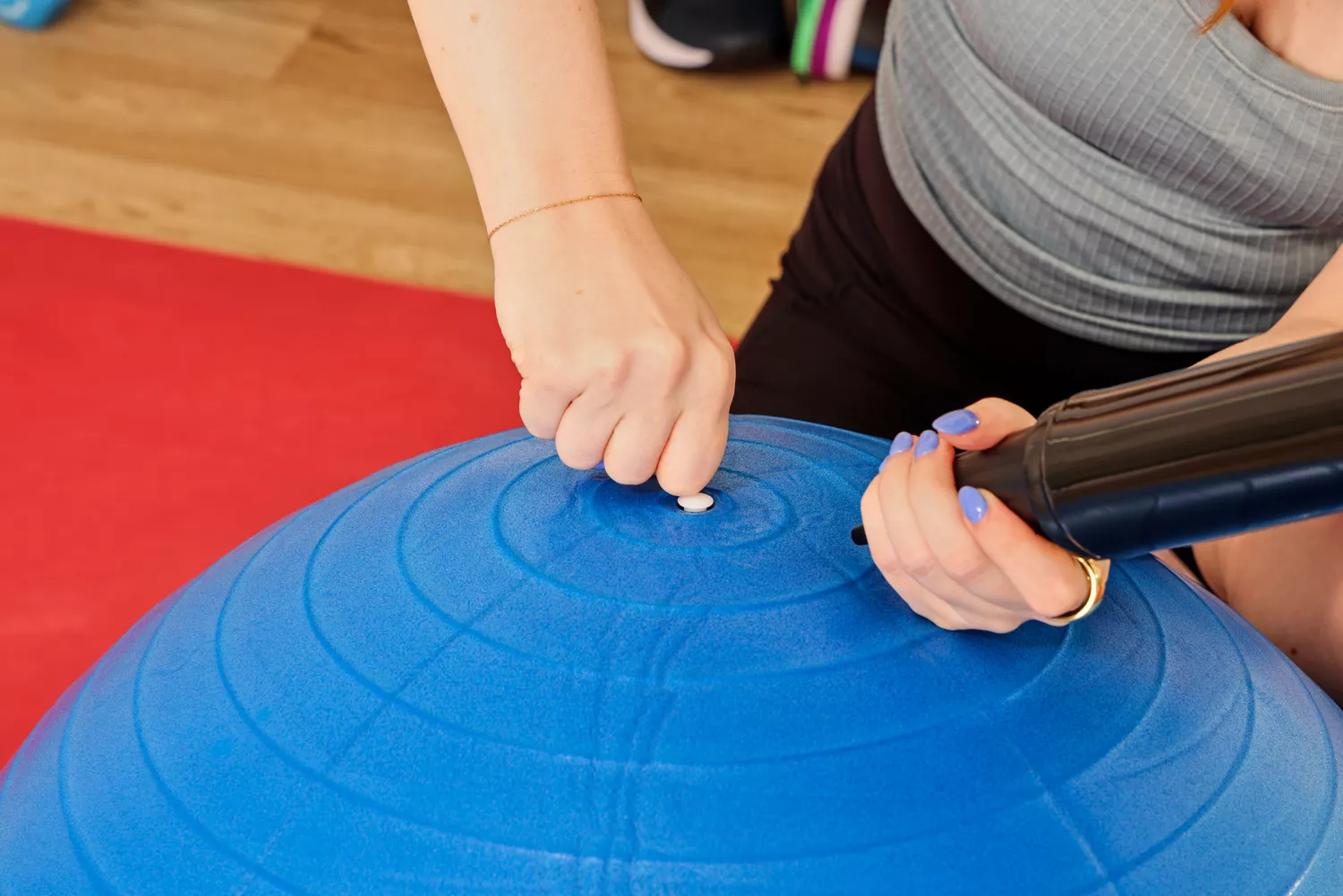 A person inflates the GalSports Anti-Sport Yoga Ball
