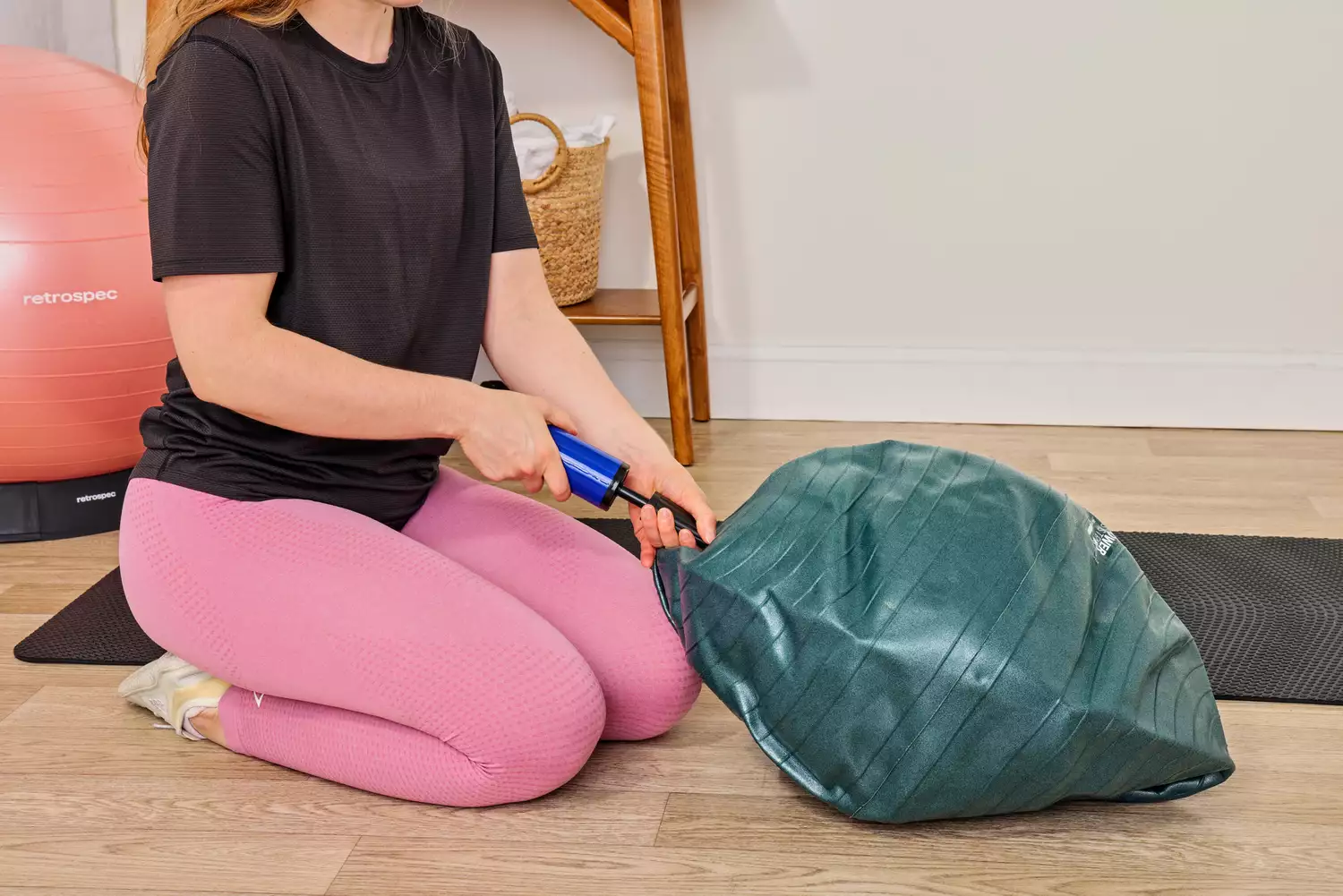 A person inflates the Power Systems Versa Ball Pro Stability Ball