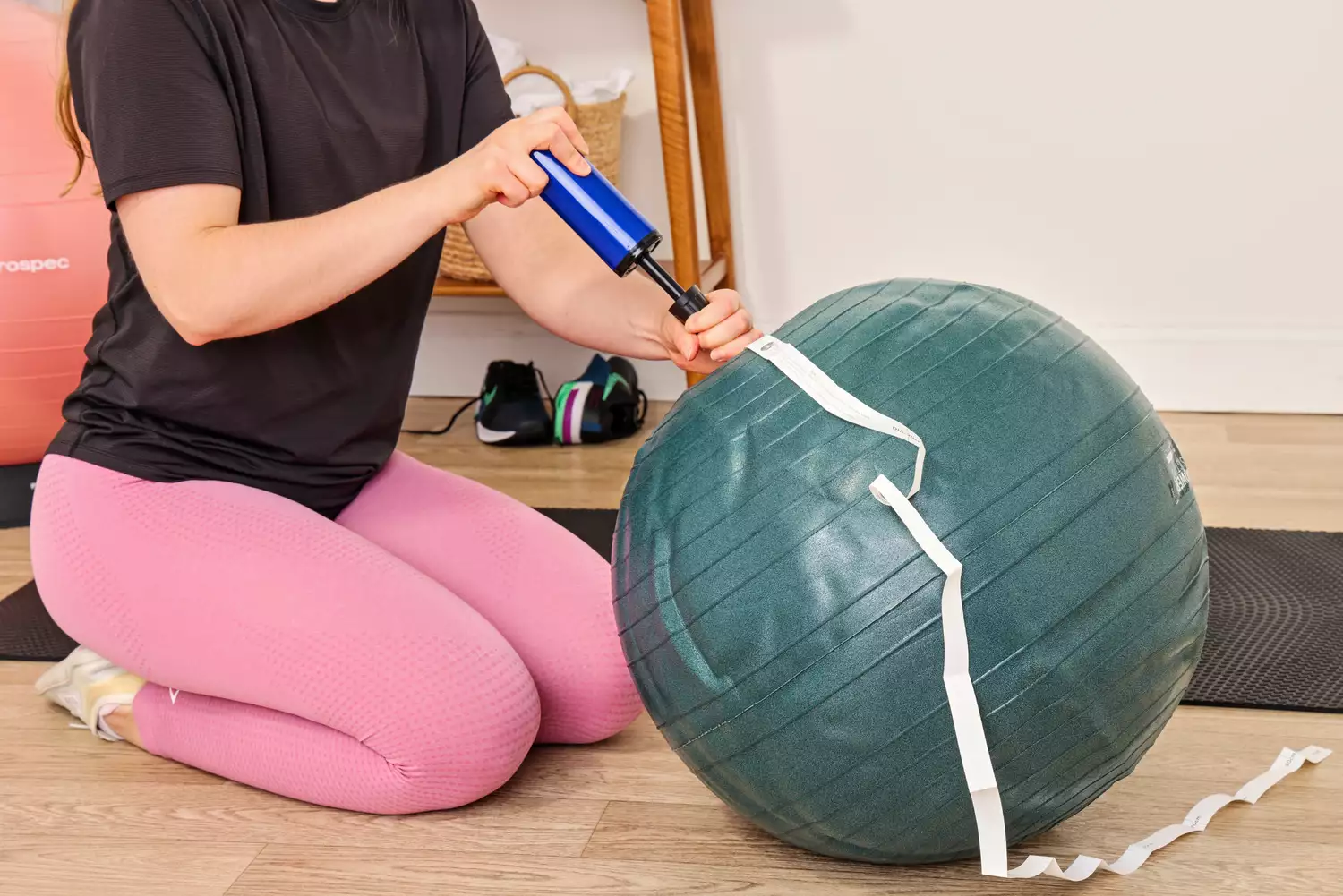 A person inflates the Power Systems Versa Ball Pro Stability Ball