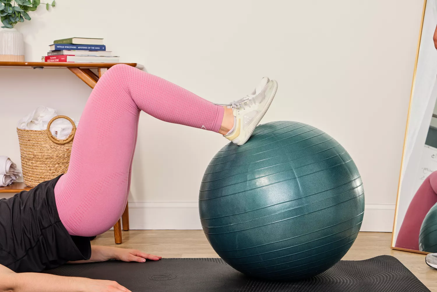 A person exercises using the Power Systems Versa Ball Pro Stability Ball