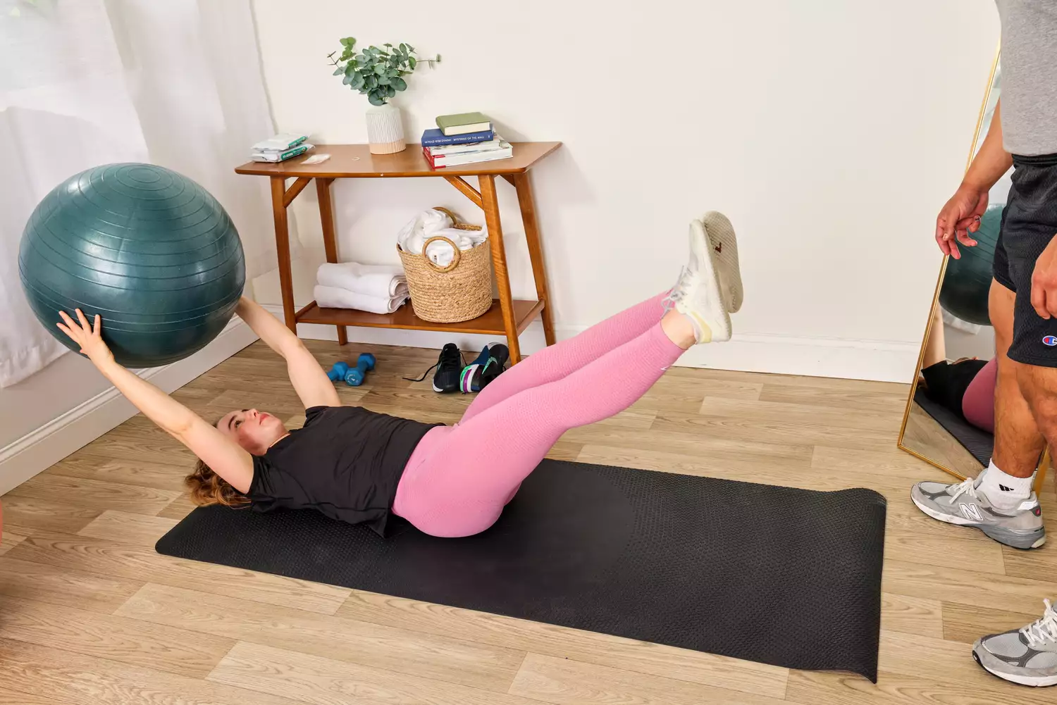 A person exercises using the Power Systems Versa Ball Pro Stability Ball