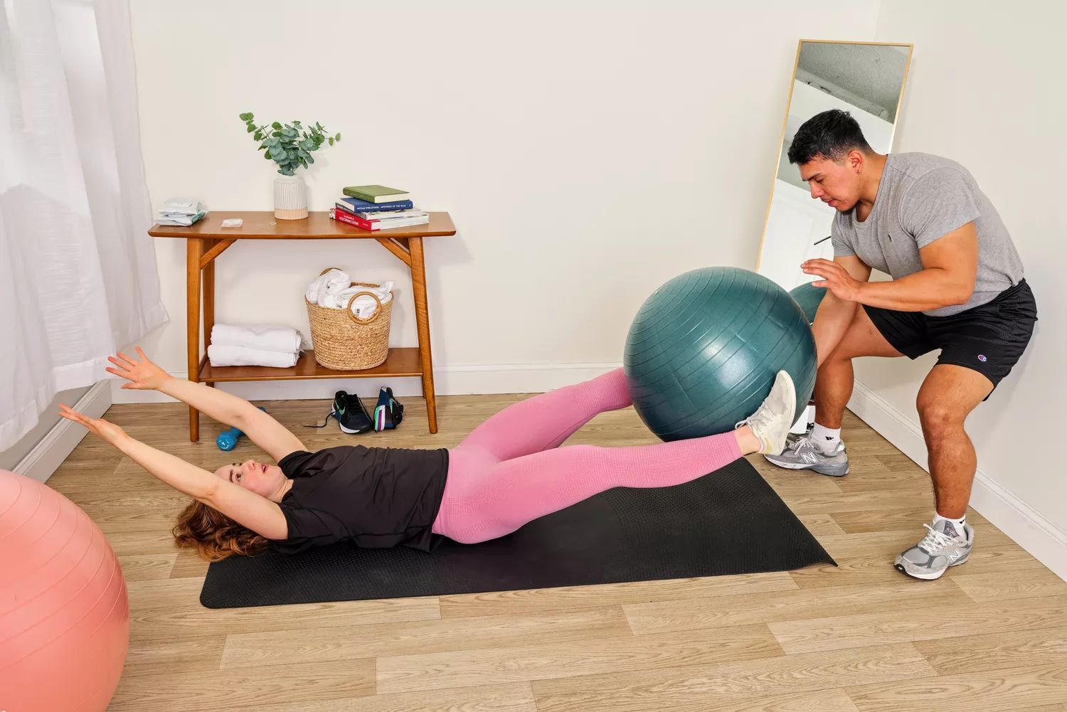 A person exercises using the Power Systems Versa Ball Pro Stability Ball