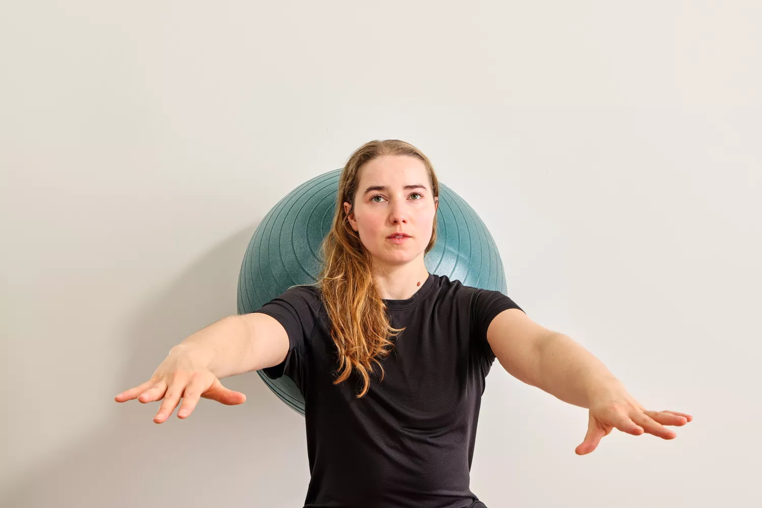 A person exercises using the Power Systems Versa Ball Pro Stability Ball