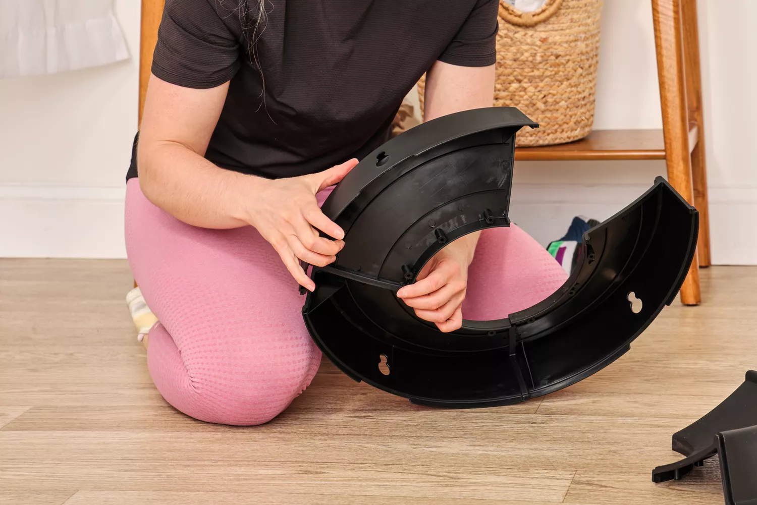 A person assembles the stand for the Retrospec Luna Exercise Ball