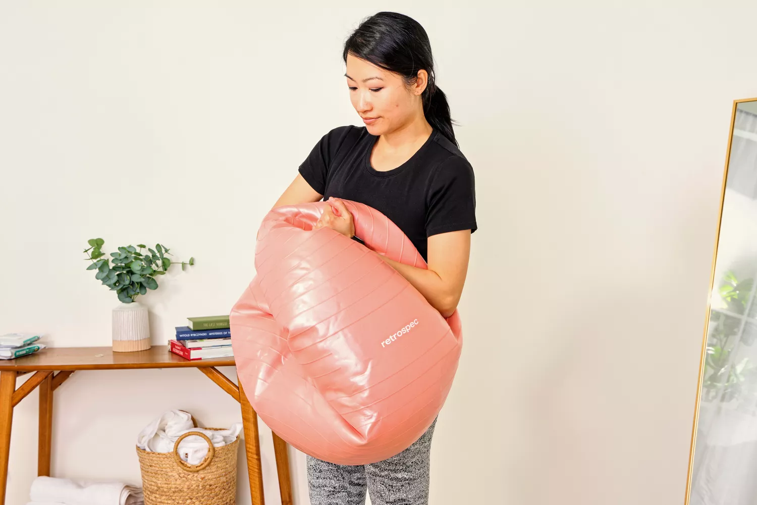 A person deflates the Retrospec Luna Exercise Ball