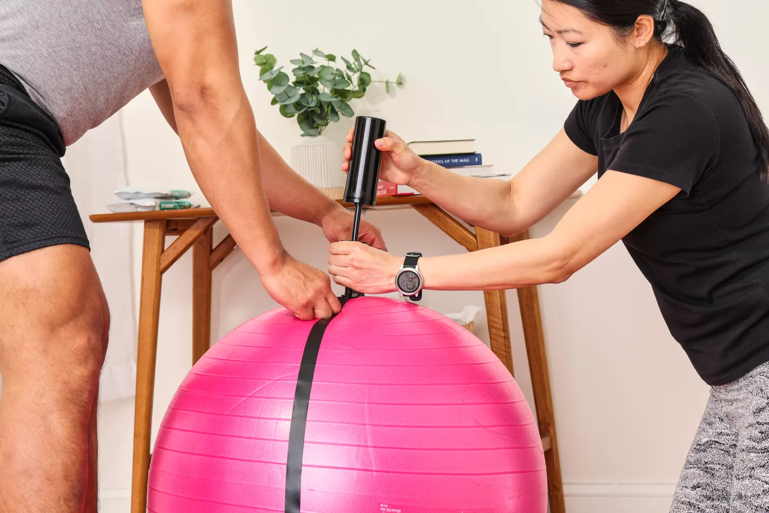 A person inflates the SmarterLife Workout Exercise Ball