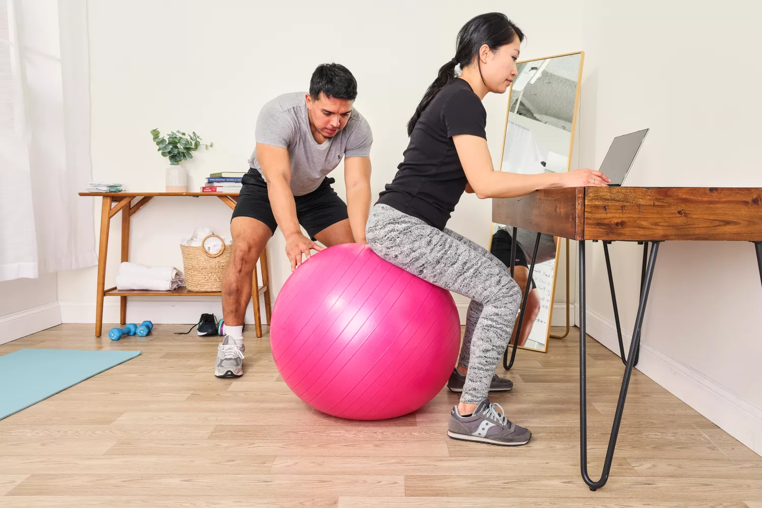 A person sits on the SmarterLife Workout Exercise Ball