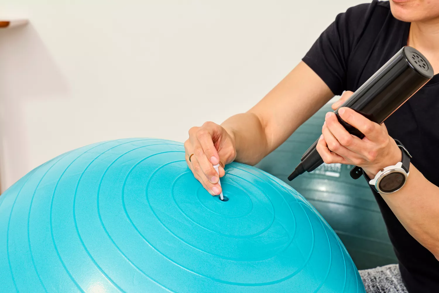 A person places a plug into the Trideer Exercise Ball Chair