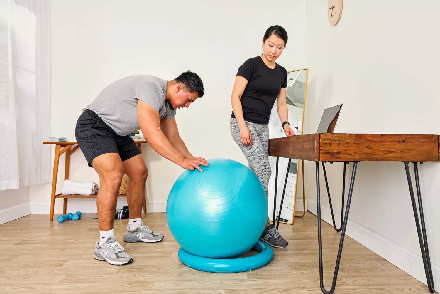 A person places the Trideer Exercise Ball Chair on its base