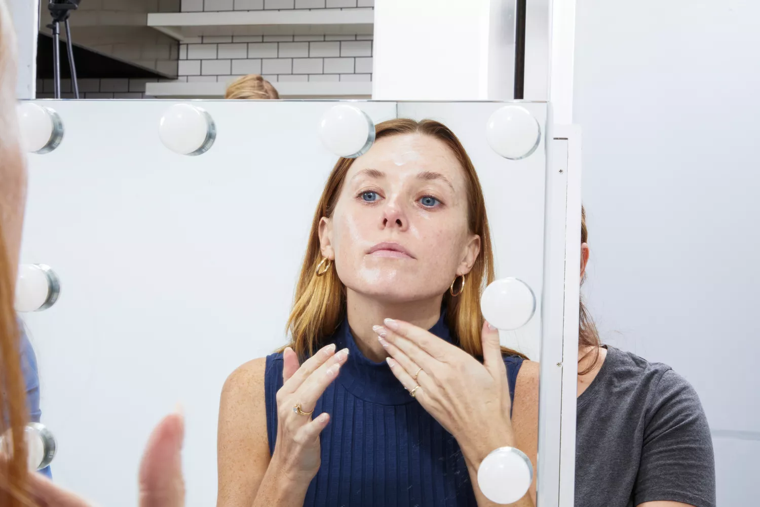 Women applying DHC Olive Virgin Oil Essential Cream on her face